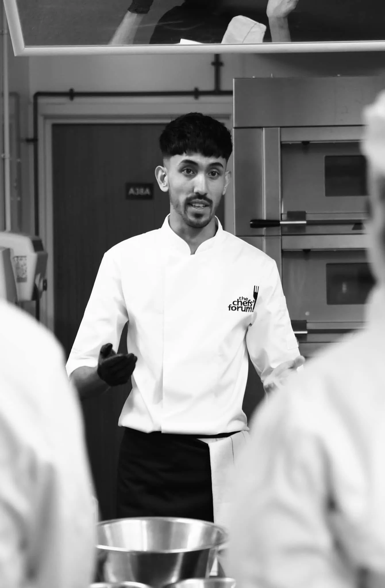 Chef Jubz teaching a class, students in the foreground.